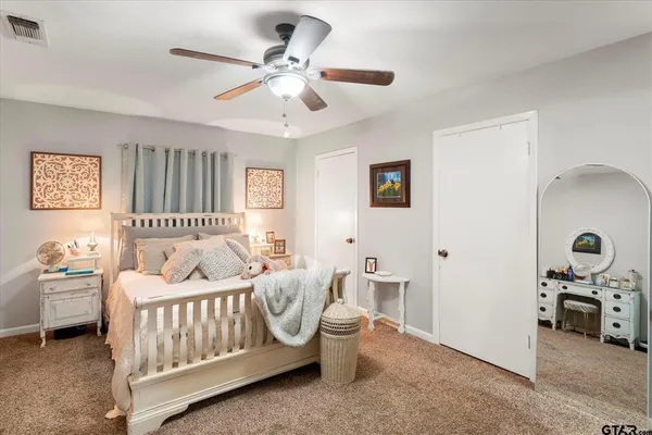 a bedroom with furniture and a large window