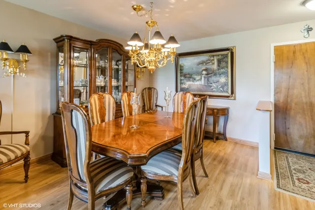 a dining room with furniture and chandelier kitchen view