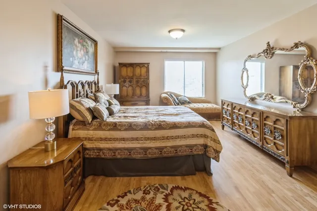 a bed sitting in a bedroom next to a window