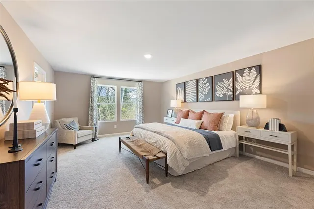 a spacious bedroom with a bed and a couch