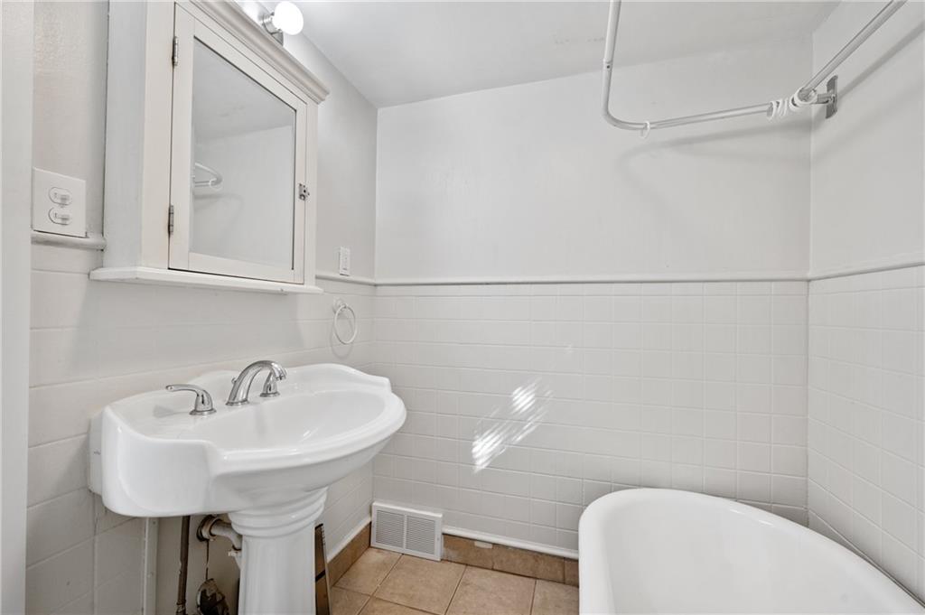 320 Newkirk Avenue Carnegie, PA 15106 - Photo 11 of 25 a bathroom with a sink a toilet and a mirror