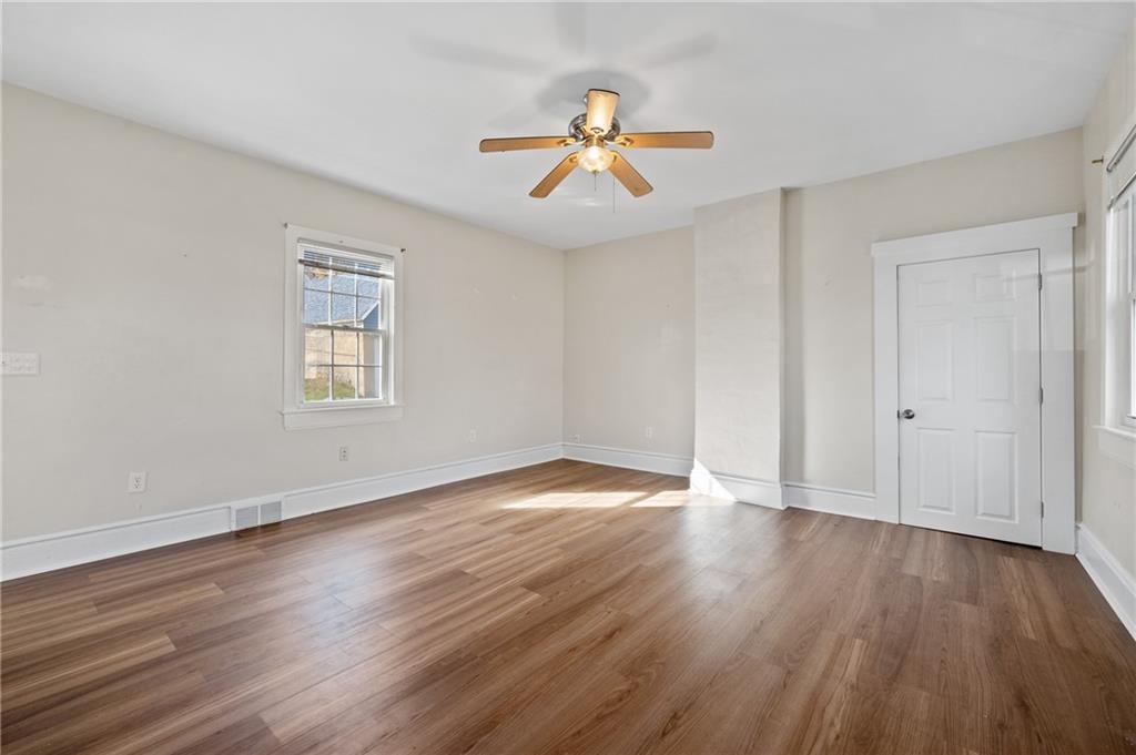 320 Newkirk Avenue Carnegie, PA 15106 - Photo 14 of 25 an empty room with wooden floor chandelier fan and windows