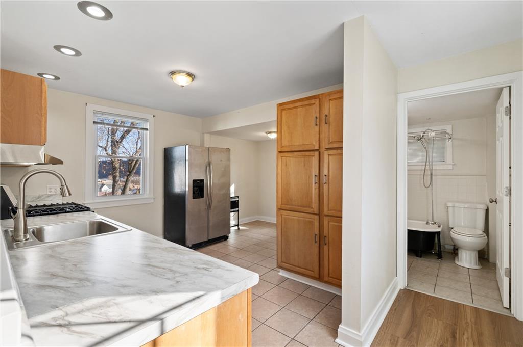 320 Newkirk Avenue Carnegie, PA 15106 - Photo 2 of 25 a kitchen with stainless steel appliances granite countertop a refrigerator and a sink