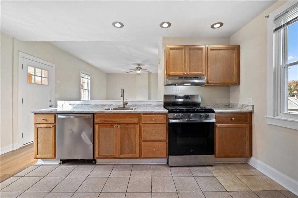 320 Newkirk Avenue Carnegie, PA 15106 - Photo 7 of 25 a kitchen with stainless steel appliances granite countertop a stove a sink and a refrigerator