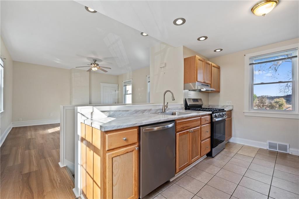 320 Newkirk Avenue Carnegie, PA 15106 - Photo 8 of 25 a kitchen with a sink stove and cabinets