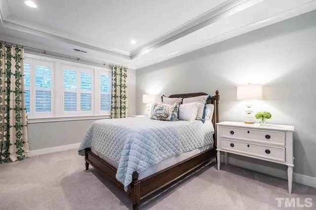 a bed sitting in a bedroom next to a window