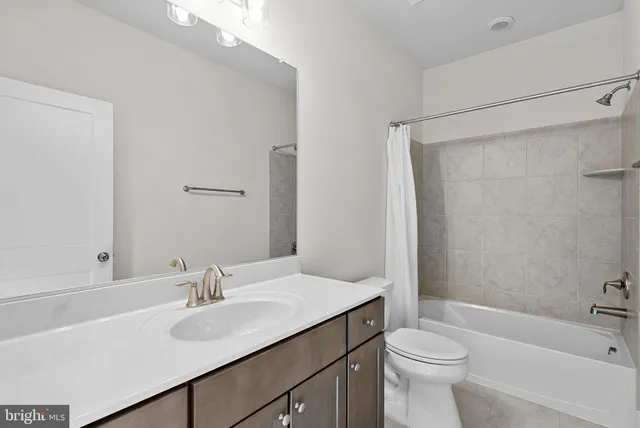 a bathroom with a sink toilet a mirror and shower