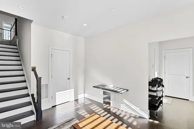 a view of entryway with stairs and wooden floor