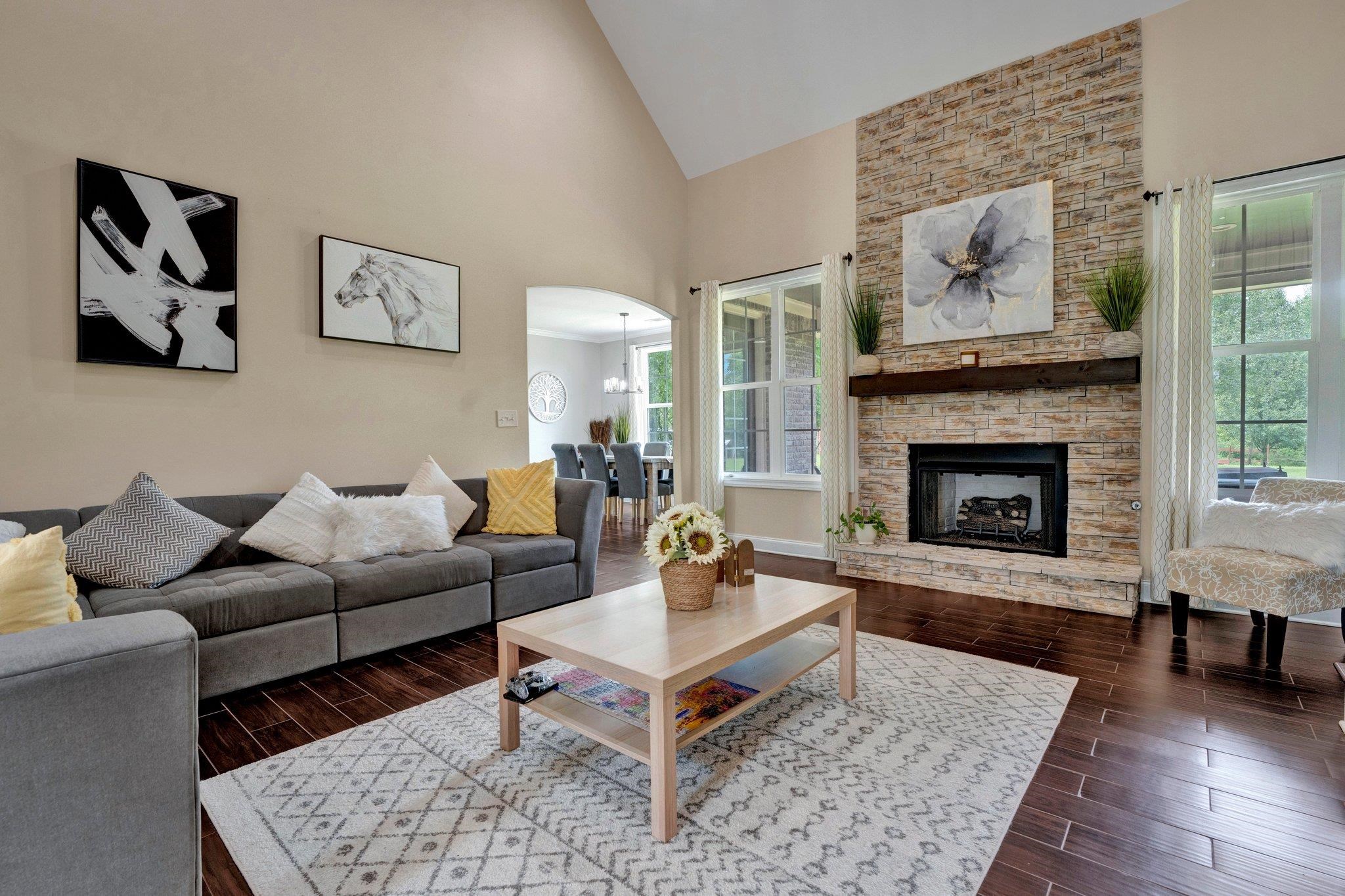 3270 Rast Road Millington, TN 38053 - Photo 7 of 40 Living area with arched walkways, high vaulted ceiling, dark wood-style flooring, and a fireplace