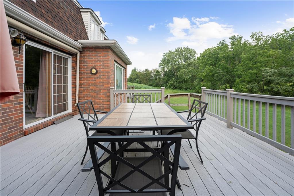 298 Rolling Hills Road Ruffs Dale, PA 15679 - Photo 22 of 25 a balcony with wooden floor table and chairs