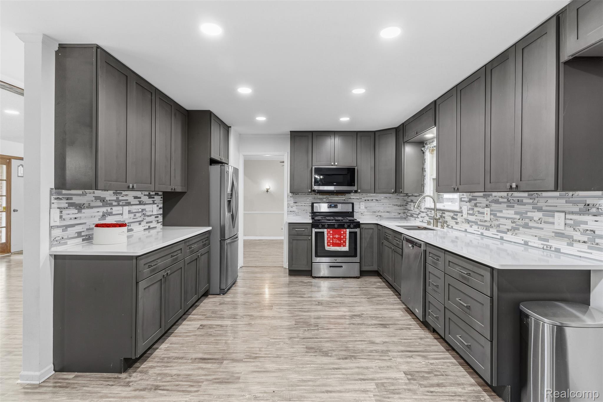 3432 South State Road Davison, MI 48423 - Photo 26 of 58 Kitchen with stainless steel appliances, recessed lighting, light stone counters, light wood-style floors, and decorative backsplash