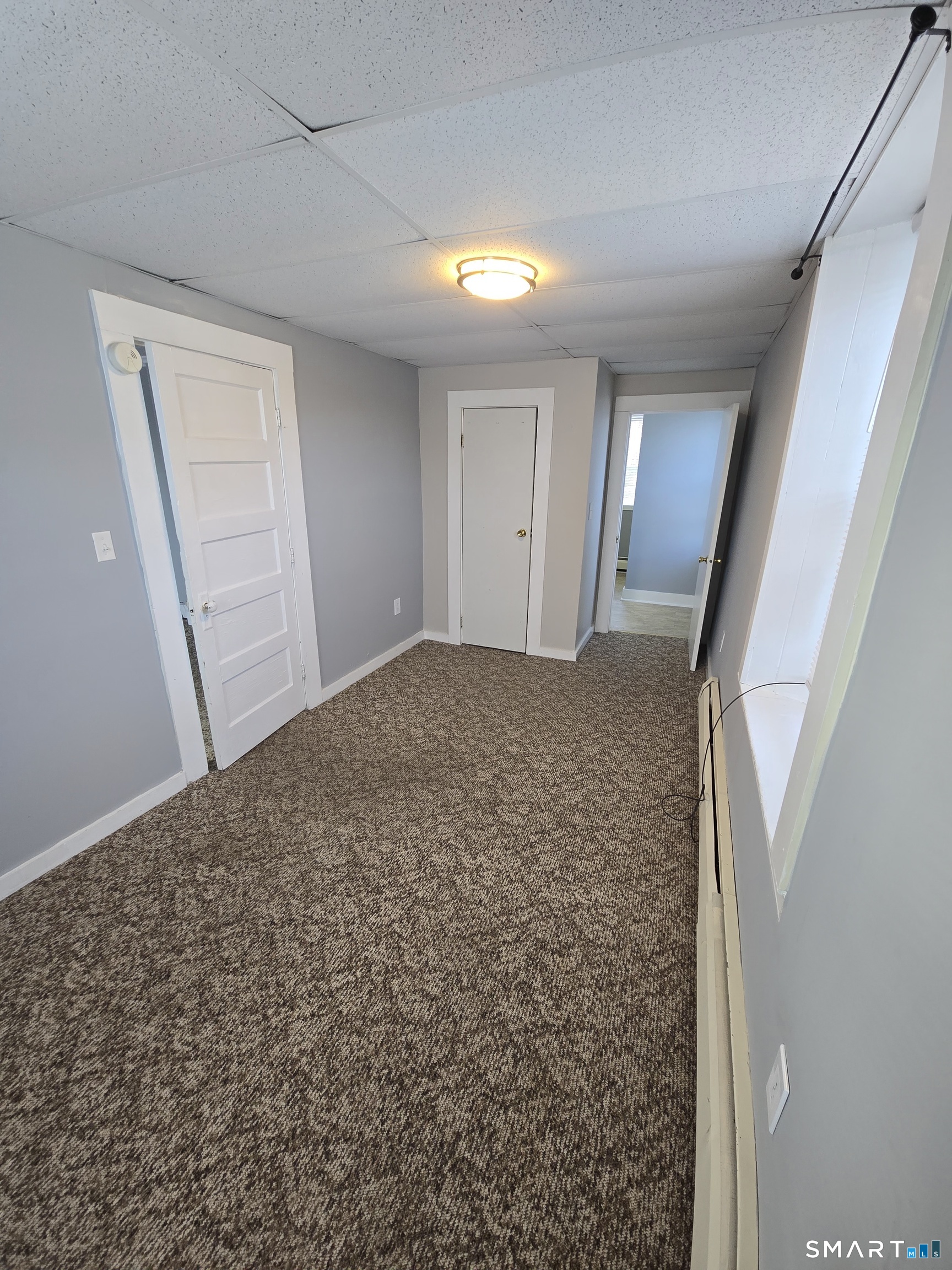 a view of a big room with wooden floor and staircase