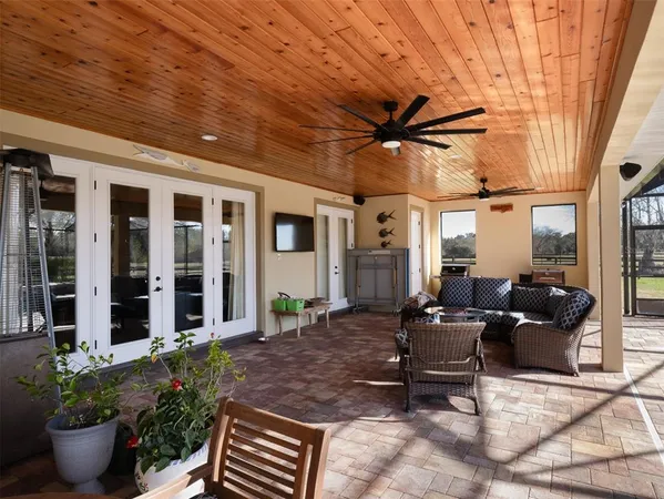 a building outdoor space with patio furniture and potted plants
