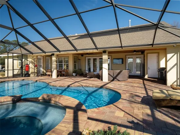 a view of a backyard with swimming pool