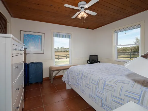 a bedroom with a bed dresser and a window