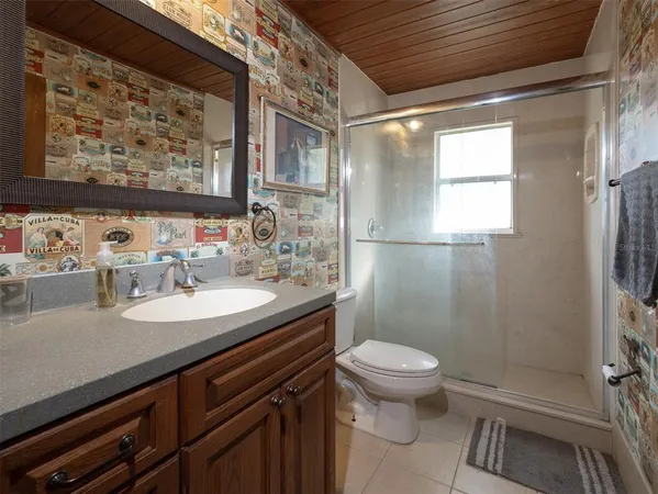 a bathroom with a sink a toilet a shower and a mirror
