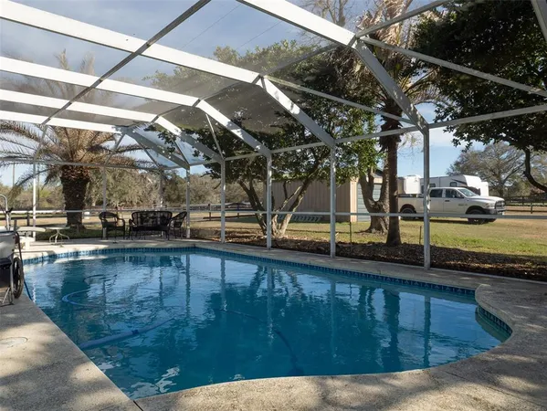 a view of a swimming pool with a patio