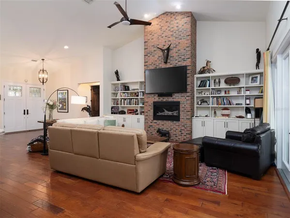 a living room with furniture a flat screen tv and a fireplace