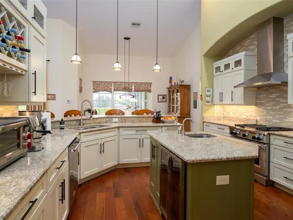 a kitchen with stainless steel appliances granite countertop a stove sink and cabinets