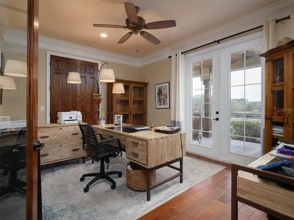 a view of a livingroom with workspace and a window