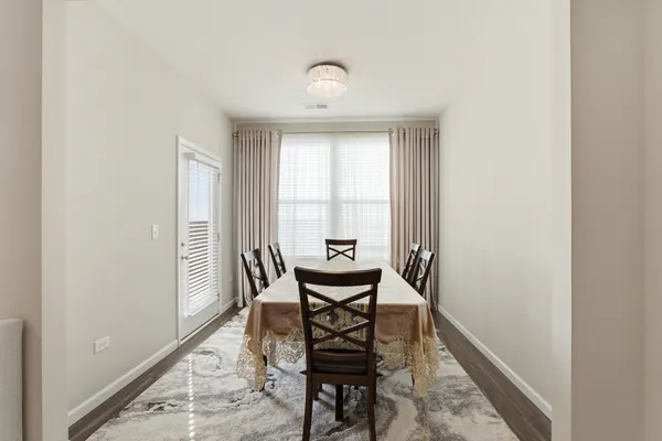 a dining room with furniture and window