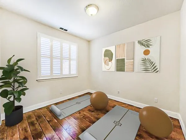 a bed sitting in a bedroom next to a window