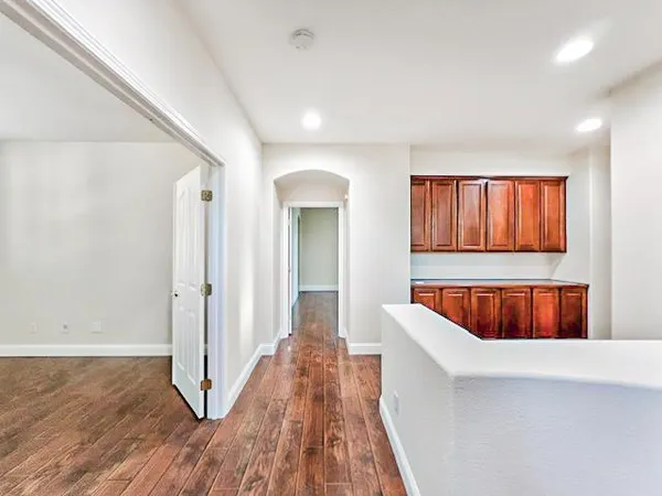 a view of a kitchen with a tub and wooden floor