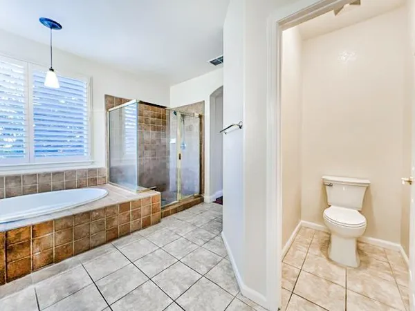 a bathroom with a granite countertop sink a toilet and bathtub