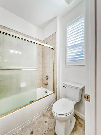 a bathroom with a toilet and a bathtub
