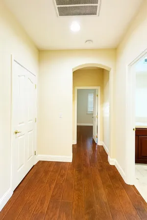 a view of a hallway with wooden floor
