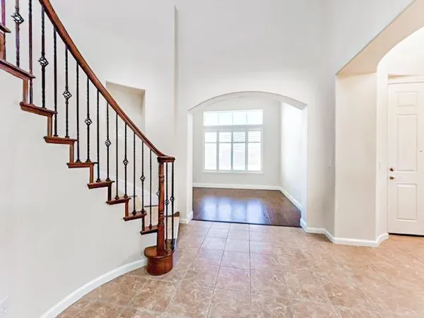 a view of staircase with lots of frames on wall and stairs