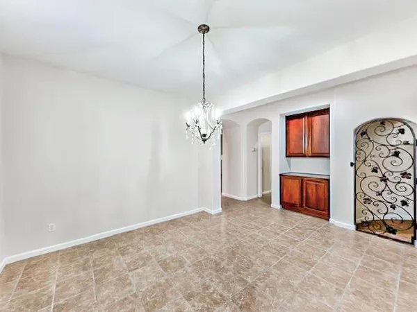 a view of a livingroom with a chandelier fan and windows