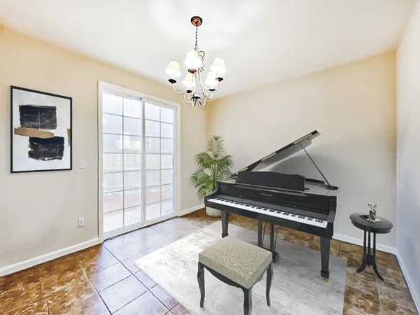 a living room with furniture a window and a chandelier