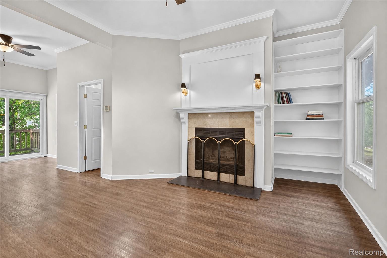8114 Chilson Road Pinckney, MI 48169 - Photo 7 of 32 Living space featuring wood-finish flooring and a corner fireplace with a mantel