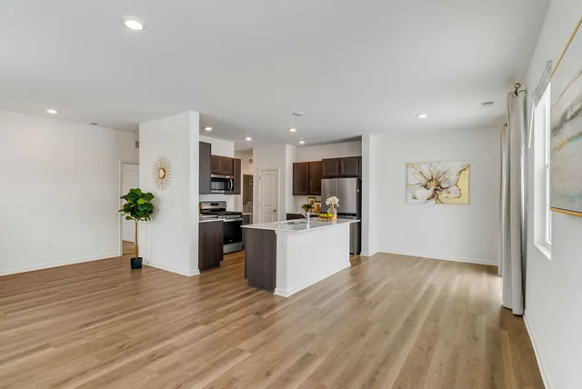 a view of kitchen with wooden floor and electronic appliances