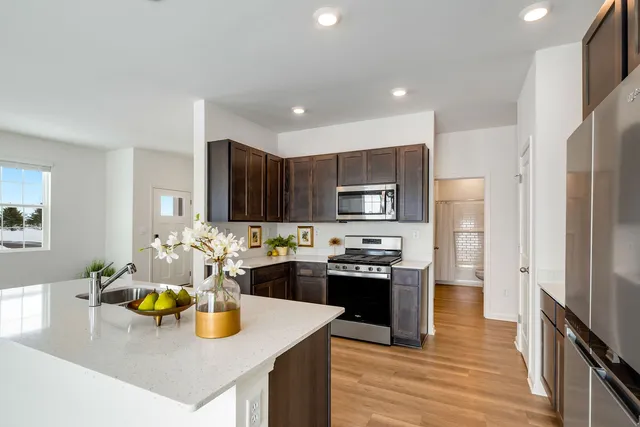 a kitchen with sink and refrigerator