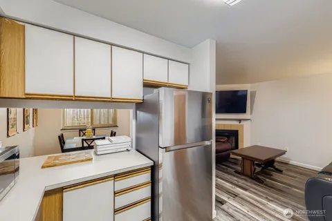 a kitchen with a appliances a refrigerator and a stove top oven