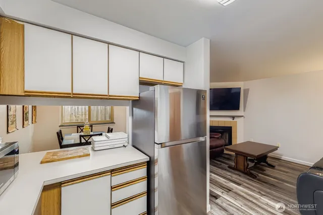 a kitchen with a appliances a refrigerator and a stove top oven