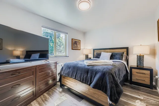 a bedroom with a bed and a lamp