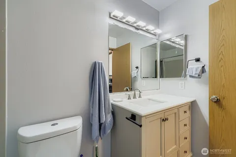 a bathroom with a sink toilet and mirror