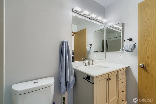 a bathroom with a sink toilet and mirror