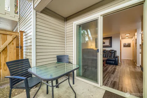 a balcony view with a dining table and chairs