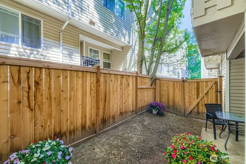 a backyard of a house with flower plants