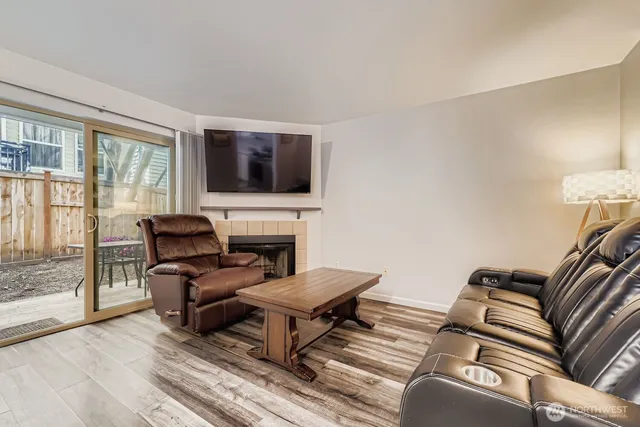 a living room with furniture a flat screen tv and a fireplace