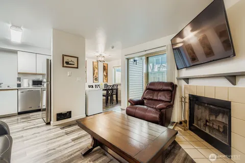 a living room with furniture fireplace and flat screen tv