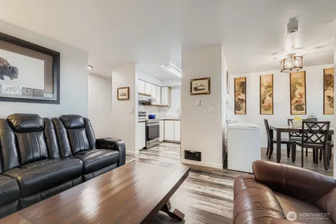 a living room with furniture and a dining table