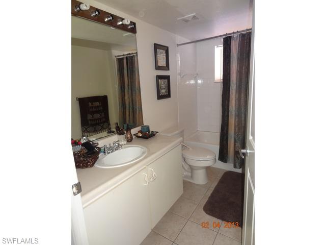8284 Key Royal Circle, Unit 1332 Naples, FL 34119 - Photo 8 of 13 a bathroom with a sink toilet and mirror