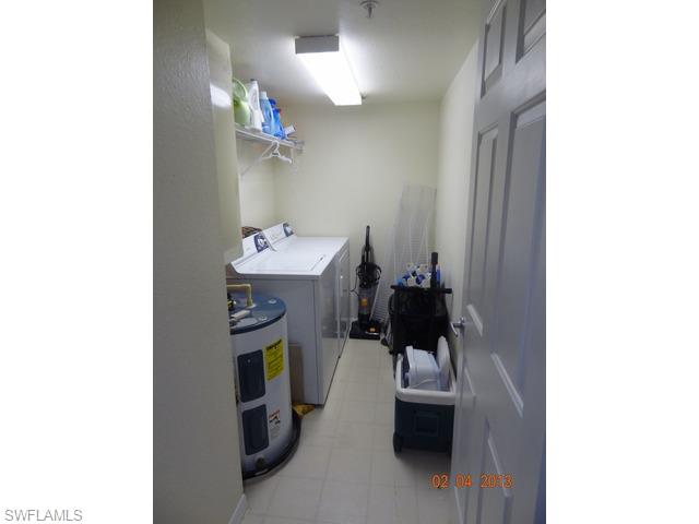 8284 Key Royal Circle, Unit 1332 Naples, FL 34119 - Photo 9 of 13 a room with a sink and a mirror