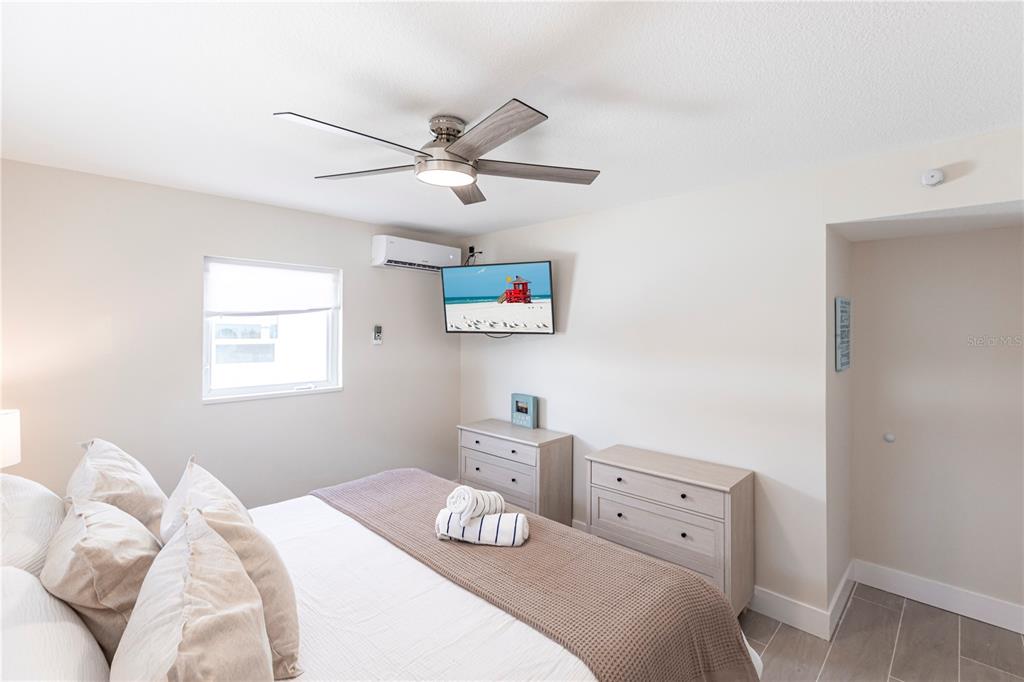 6020 Midnight Pass Road, Unit 15 Sarasota, FL 34242 - Photo 12 of 19 a bedroom with a bed and a window