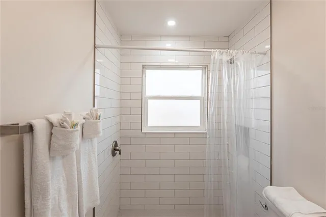 a bathroom with a shower and a toilet